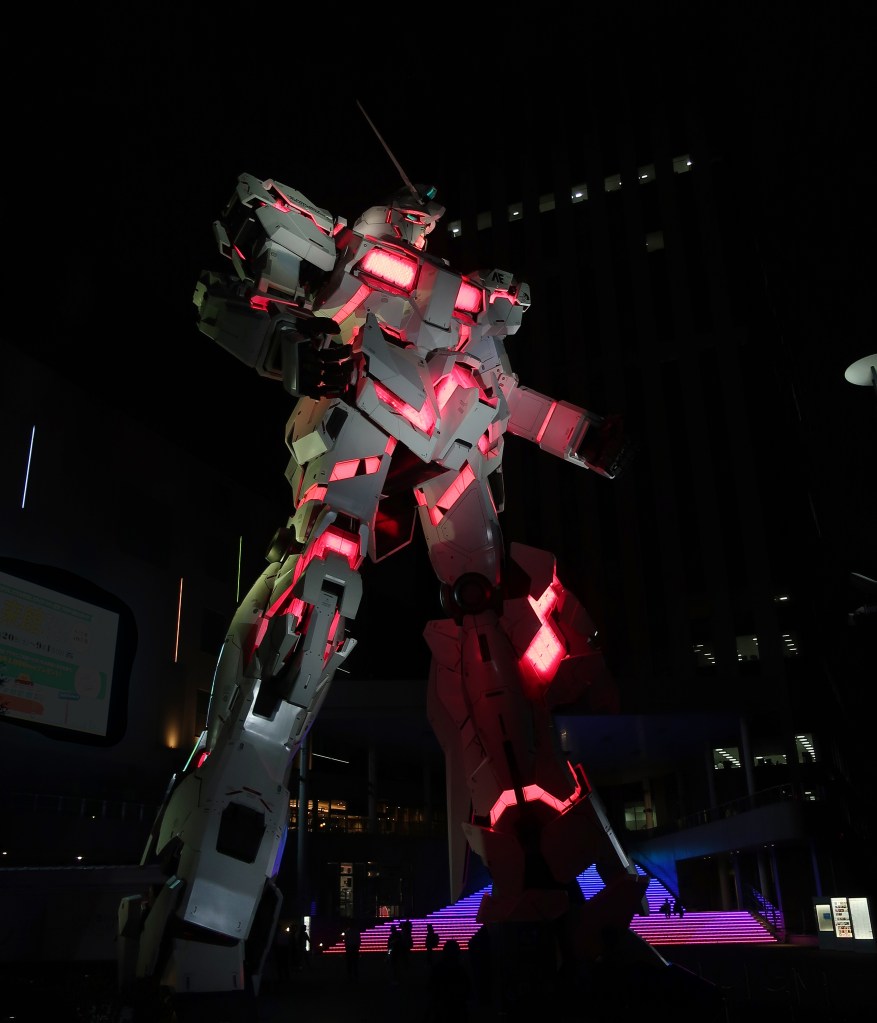 Giant Gundam Unicorn lit up at night