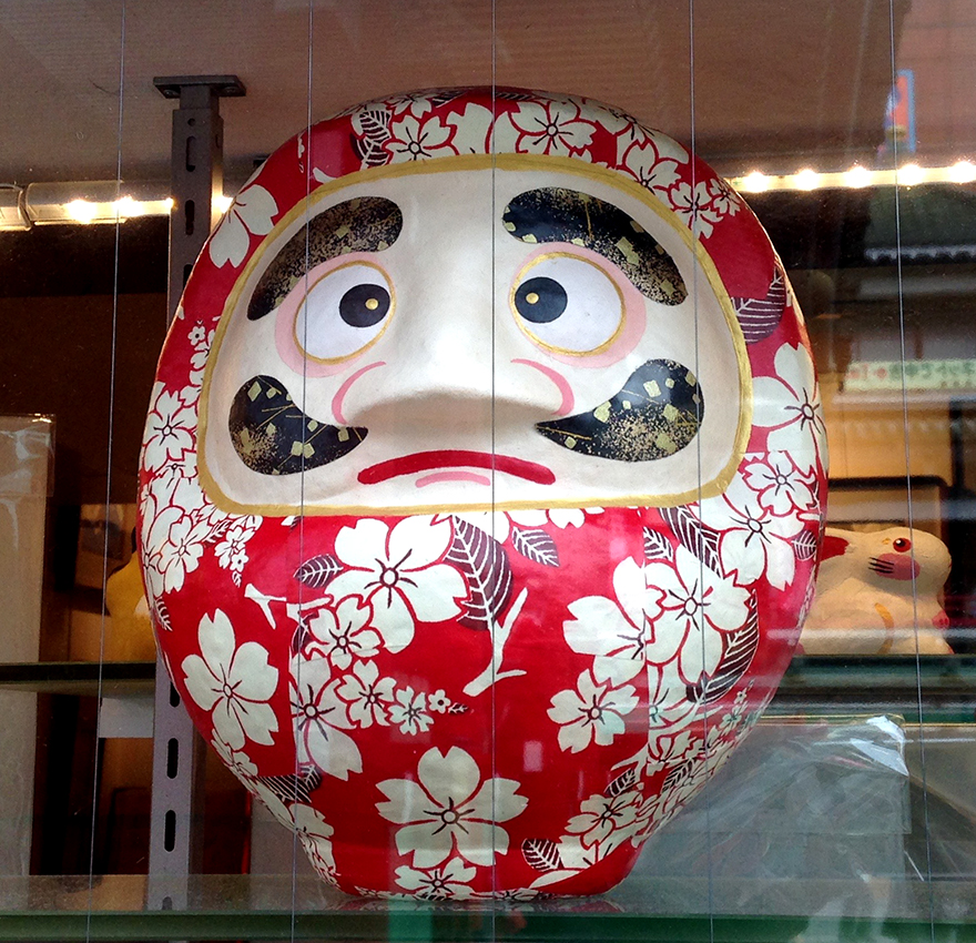 Daruma figure covered with cherry blossom washi paper