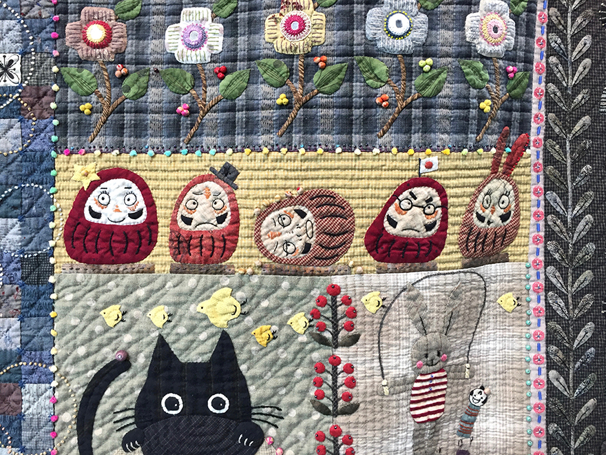 Daruma figures on quilt