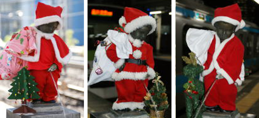 The nude peeing boy statue at JR Hamamatsucho station dressed as Santa in the years 2012, 1013, 2014